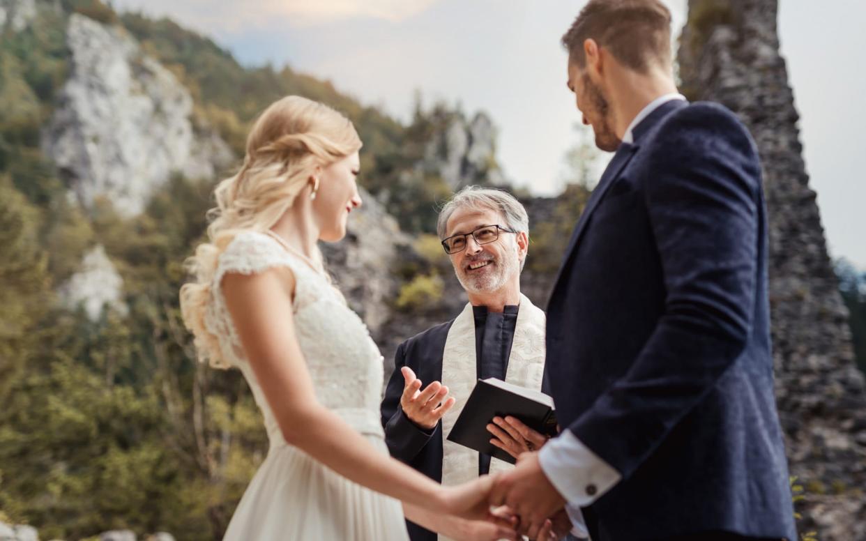 A couple have a religious wedding ceremony with a priest - meaning they are allowed 30 people at their service  - Getty