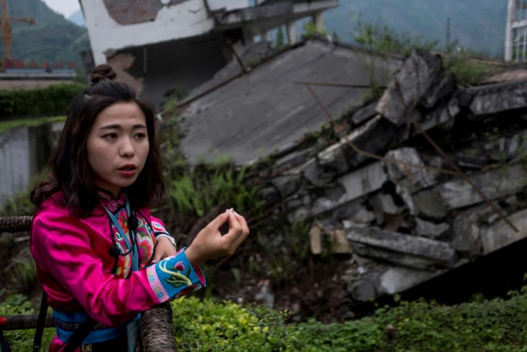 Guides shepherd tourists around the ruins of their destroyed town in the hope of explaining the tragedy of a natural disaster that left tens of thousands of people dead