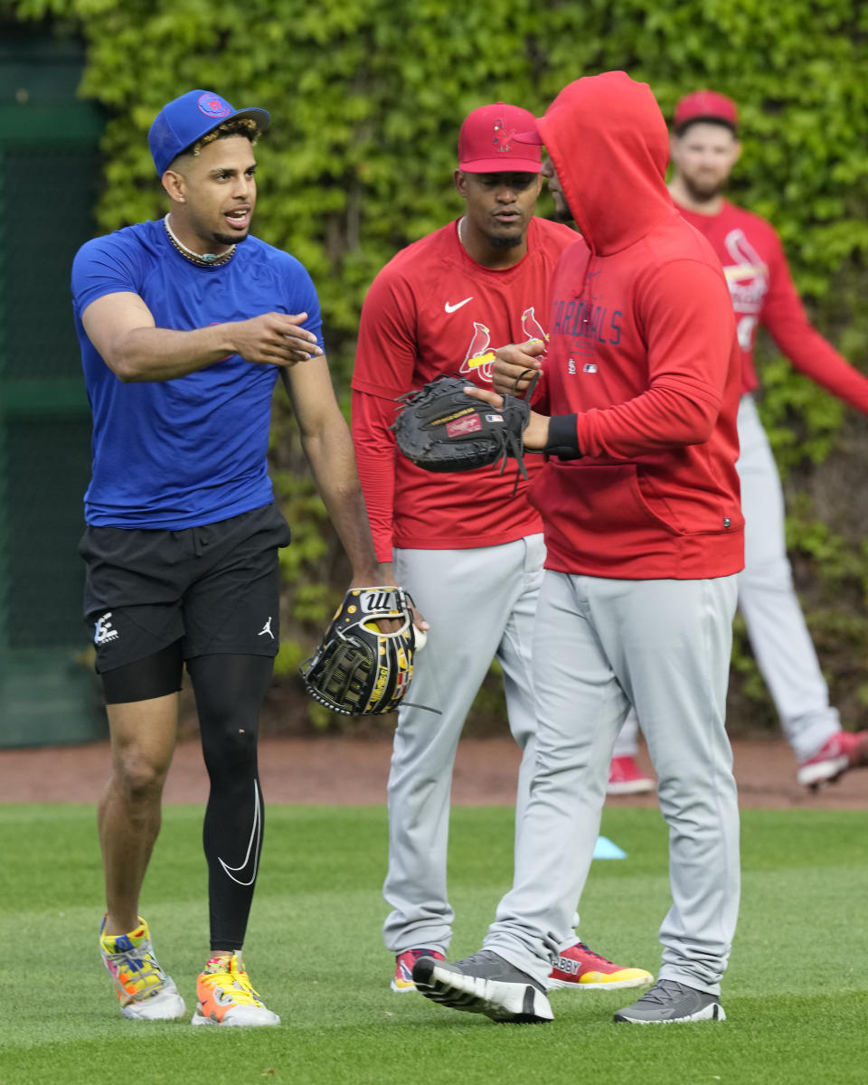 Chicago Cubs' Christopher Morel, left, talks with former teammate St. Louis Cardinals' Willson Contreras, right, before a baseball game Monday, May 8, 2023, in Chicago, Contreras returned to Wrigley Field for the first time since leaving the Cubs after last season. (AP Photo/Charles Rex Arbogast)