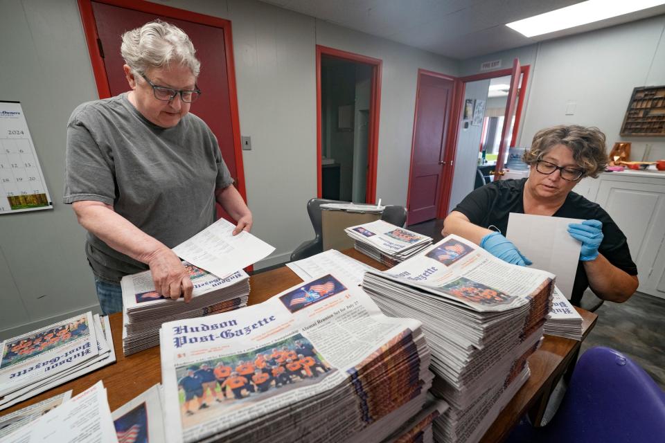 Barbara Ireland, 72, of Hudson, left, and her niece Rachel Stiverson, 53, of Hudson, prepare the Hudson Post-Gazette's Fourth of July edition for circulation on Tuesday, July 2, 2024. Ireland bought the paper in 2018 to save it from closing. Their circulation is just under 800 readers. Some of their subscribers live in other states but love to keep up with hometown news about Hudson.