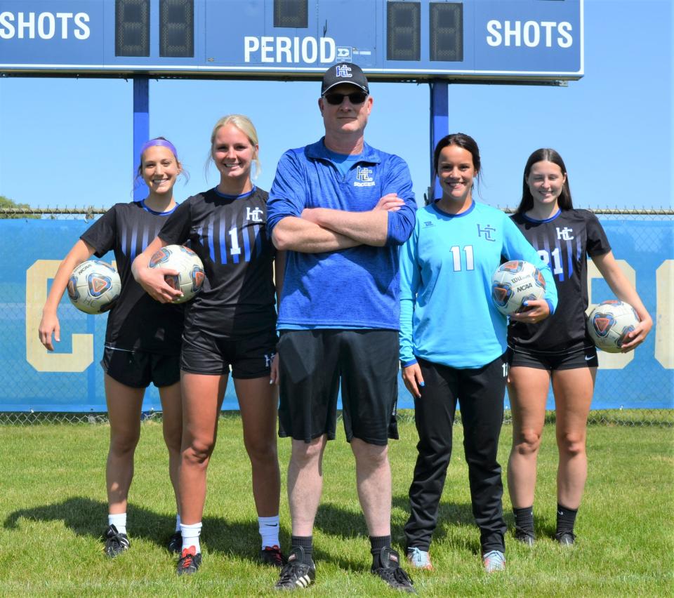 Harper Creek made history this season with the school's first-ever Interstate 8 Conference title, led by head coach Tom McNeil, center, and co-captains, from left, Lia Luchetti, Payton Rice, Lauren Higgs and Jessie Cummins.