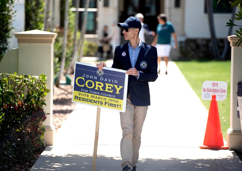 John David Corey campaigned outside the Morton & Barbara Mandel Recreation Center Tuesday. Corey and Bridget Moran are vying for the Group 3 Town Council seat in Palm Beach.