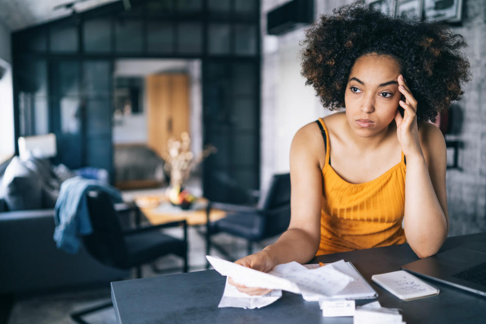 Woman looking stressed while going over financial paperwork