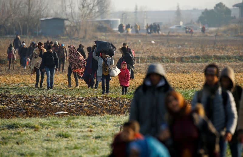 Migrants walk towards the Turkey's Pazarkule border crossing with Greece's Kastanies, near Edirne