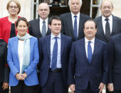 French President Francois Hollande, right front row, new French Prime Minister Manuel Valls, center, and Environment and Energy minister Segolene Royal pose during the family picture after the first weekly cabinet meeting after municipal elections, at the Elysee Palace in Paris, Friday, April 4, 2014. President Francois Hollande shook up the government this week after his Socialist Party suffered an electoral defeat in nationwide municipal elections. Among two new faces in the Cabinet is Segolene Royal, a longtime politician and mother of Hollande's children, as environment and energy minister. Second row are, from the left: Marylise Lebranchu, State Reform and Public Service minister, Bernard Cazeneuve, Interior Minister, Francois Rebsamen, Labor Minister, and Jean-Yves le Drian, Defense Minister. (AP Photo/Jacques Brinon)