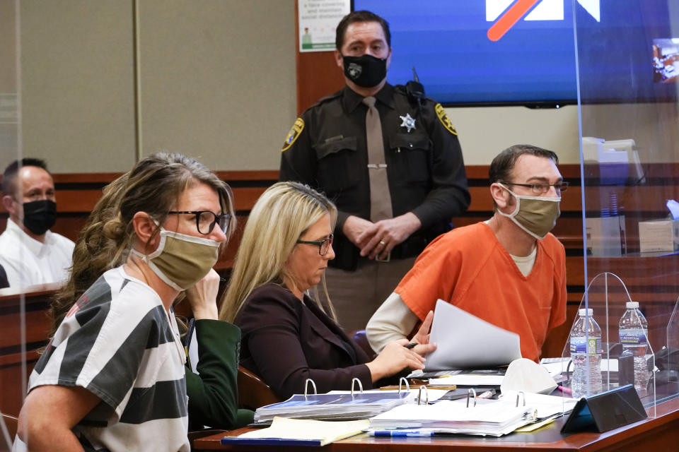 FILE - Jennifer Crumbley, left, and James Crumbley, right, the parents of Ethan Crumbley, a teenager accused of killing four students in a shooting at Oxford High School in Oxford, Mich., appear in court for a preliminary examination on involuntary manslaughter charges in Rochester Hills, Mich., Feb. 8, 2022. On Tuesday, Nov. 29, the Michigan Supreme Court postponed the January 2023 trial for Jennifer and James Crumbley, a victory for defense lawyers who argue that involuntary manslaughter charges do not fit. (AP Photo/Paul Sancya, File)