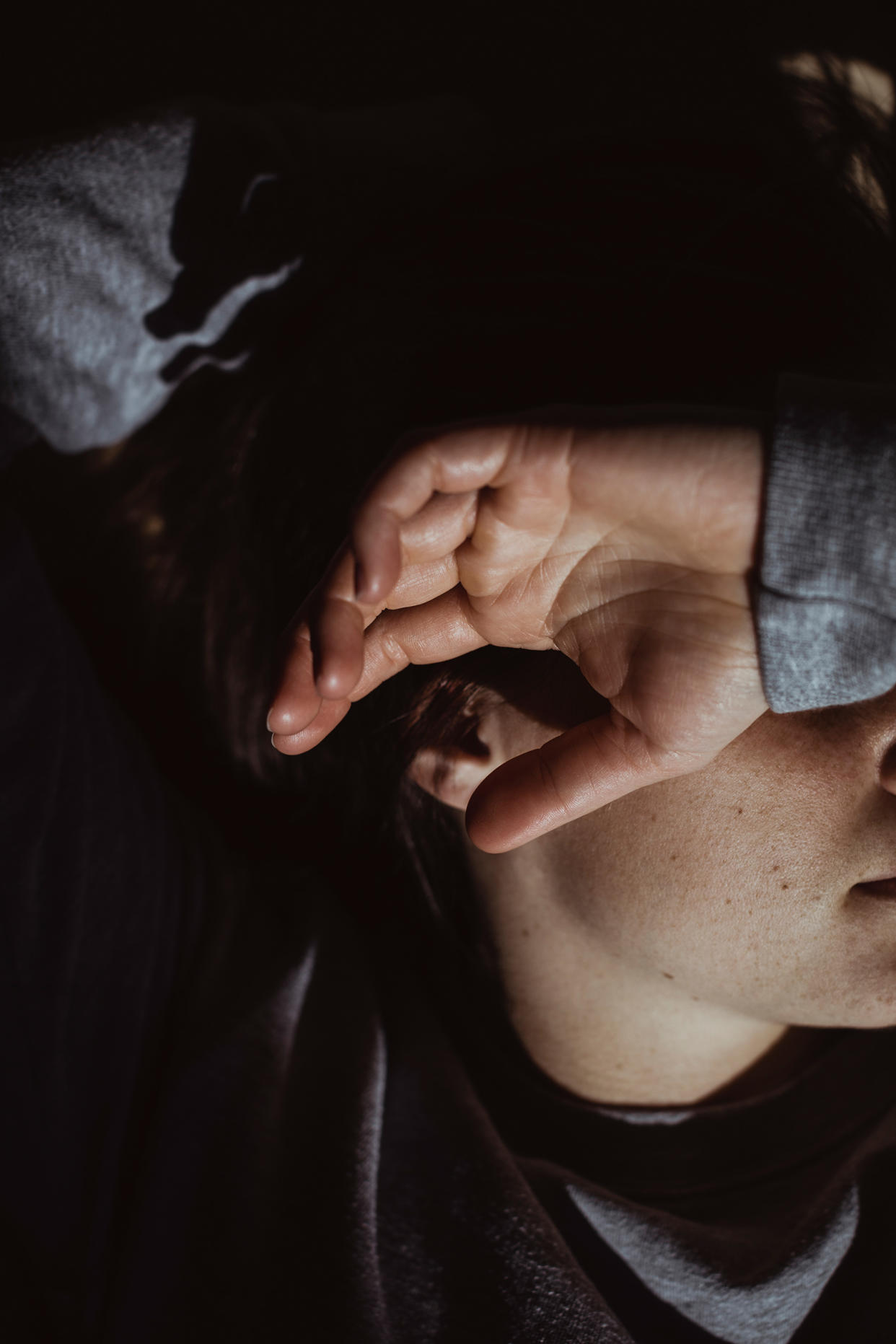 Close-up of stressed woman at home