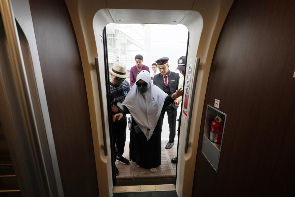 A women boards a high-speed train during a test ride at Tegalluar station in Bandung, West Java province, Indonesia, on Sept. 18, 2023. Indonesia is launching Southeast Asia’s first high-speed railway, a key project under China’s Belt and Road infrastructure initiative that will cut travel time between the capital and another major city from the current three hours to about 40 minutes. (AP Photo/Achmad Ibrahim)