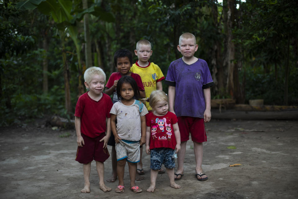 Siblings from left to right; Ender, 6, Gisell, 4, Diere, 9, Baker, 11, Ashley, 3, Watson, 12, pose for a photo near their home in Palestina, in Peru's Ucayali region, Wednesday, Sept. 30, 2020. Their 36-year-old father Ender Rengifo told The Associated Press that his entire family had symptoms related to COVID 19 in April, and were given medicinal plants from the jungle to treat the virus due to the distance from healthcare centers and the cost of medicines. (AP Photo/Rodrigo Abd)