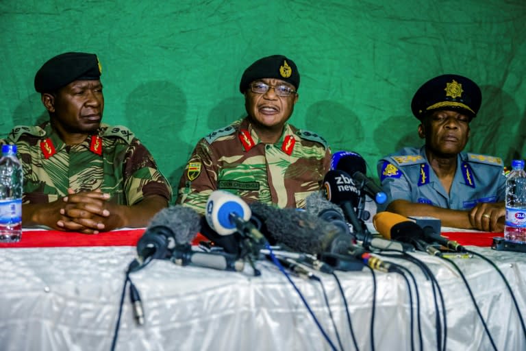 Zimbabwe's army chief Constantino Chiwenga (C) told reporters that progress had been made in talks towards an apparent exit deal for Mugabe, the world's oldest head of state