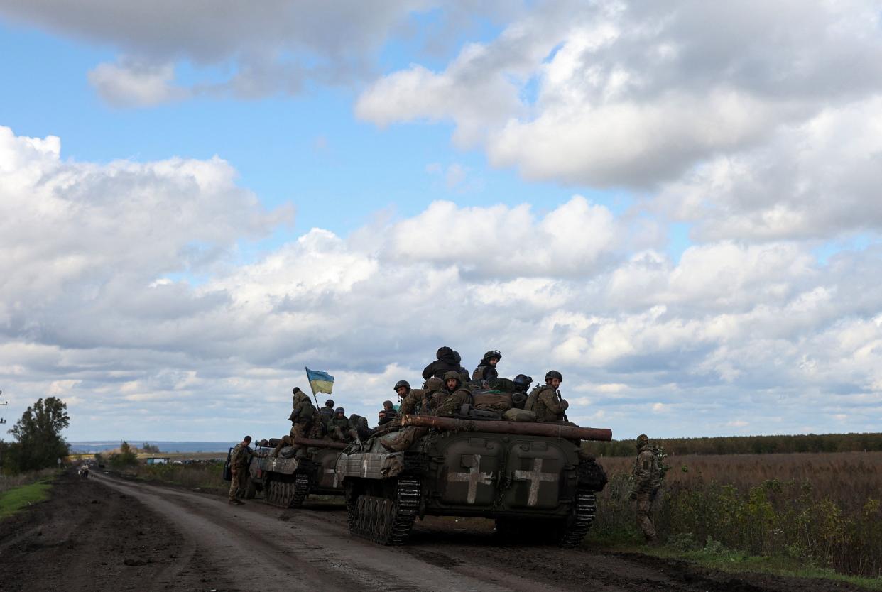 Ukrainian soldiers ride on a personnel armoured carrier on a road near Lyman, Donetsk region on October 4, 2022, amid the Russian invasion of Ukraine