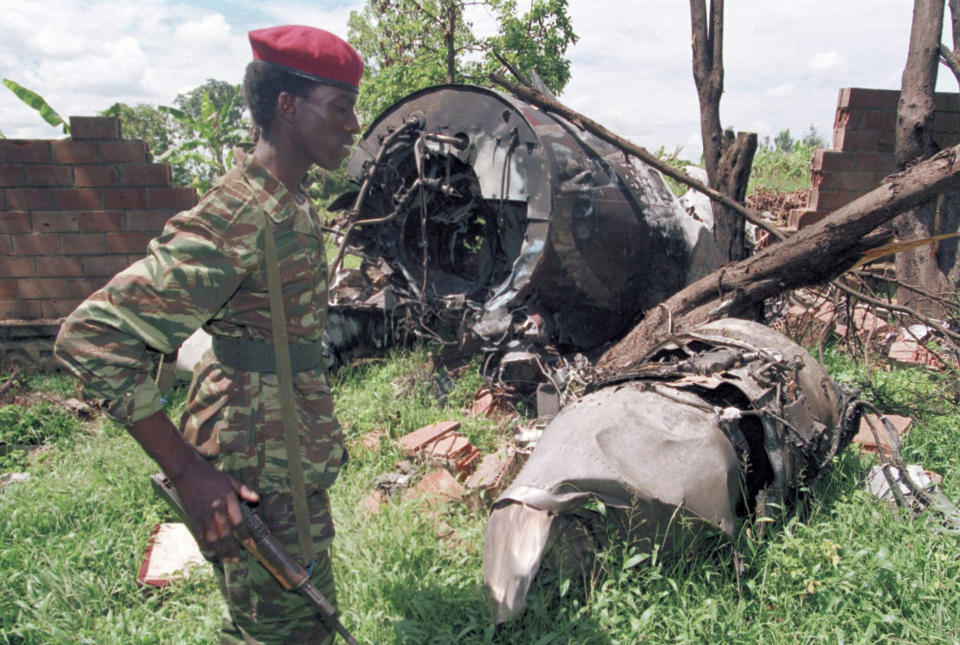 FILE - A Rwanda Patriotic Front (RPF) rebel walks on May 23, 1994, by the plane wreckage in Kigali in which Rwanda's late President Juvenal Habyarimana died on April 6. (AP Photo/Jean-Marc Bouju, File).