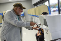 A voter turns in his ballot on Friday, Sept. 23, 2022, in Minneapolis. With Election Day still more than six weeks off, the first votes of the midterm election were already being cast Friday in a smattering of states including Minnesota. (AP Photo/Nicole Neri)