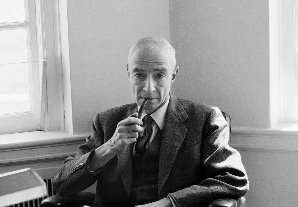 Dr. J. Robert Oppenheimer puffs pipe during an interview at the Institute for Advanced Study at Princeton, N.J., on April 5, 1963, after he was named winner of the Enrico Fermi Award. The award is the highest honor given by the Atomic Energy Commission, the same agency that declared Oppenheimer a security risk in 1954. He has headed the institute at Princeton since 1957.