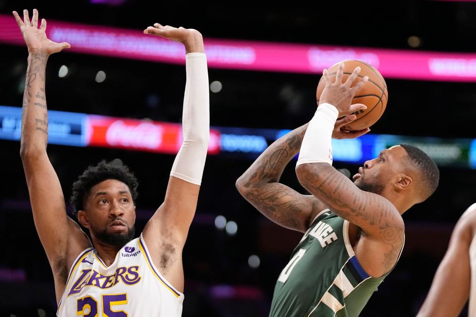 Bucks guard Damian Lillard goes up for a shot against Lakers forward Christian Wood during the first half Sunday night. Lillard finished with 14 points in his debut in a Milwaukee uniform.