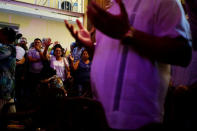 People react during a religious ceremony where victims of the Boeing 737 plane crash were remembered at a church in Havana, Cuba, May 20, 2018. REUTERS/Alexandre Meneghini