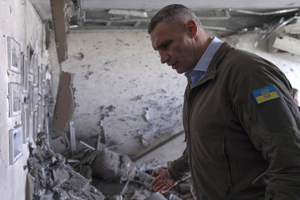 Kyiv Mayor Vitali Klitschko reacts standing in an apartment building damaged by a drone that was shot down during a Russian overnight strike, amid Russia's attack, in Kyiv, Ukraine, Monday, May 8, 2023. (AP Photo/Andrew Kravchenko)