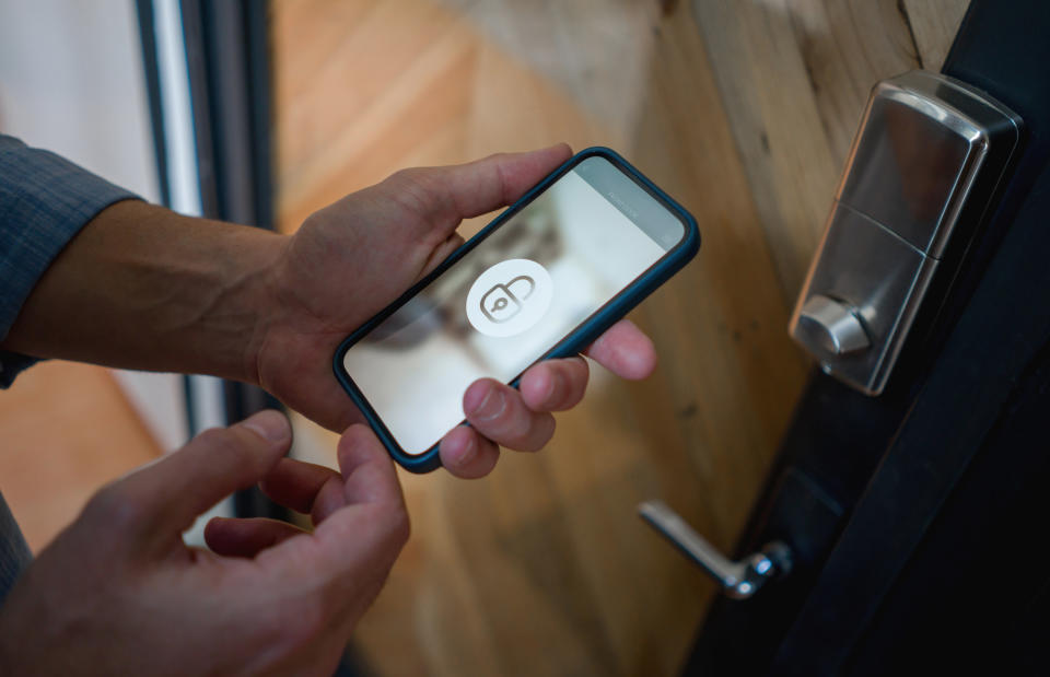 Person using their phone to unlock a door