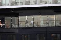 Crew members sanitise a table as the Mein Schiff 6 cruise ship is moored at the dock of Piraeus after some of the crew members tested positive for the coronavirus disease (COVID-19), in Piraeus