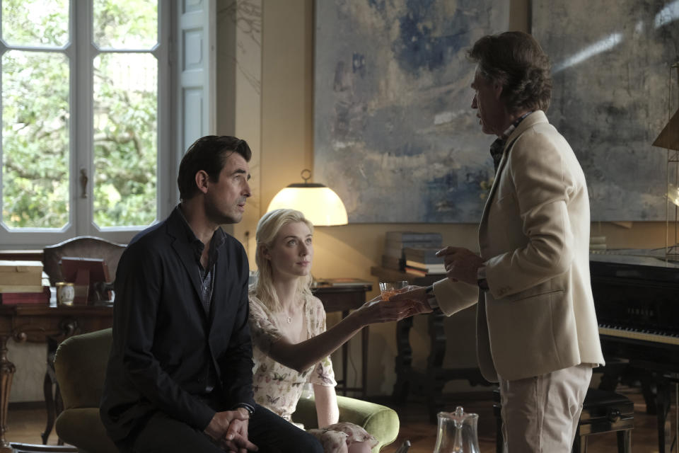 This image released by Sony Pictures Classics shows Mick Jagger, right, with Elizabeth Debicki and Claes Bang, left, in a scene from the film, "The Burnt Orange Heresy." Jagger plays a devilish art collector who cunningly convinces an art journalist, portrayed by Bang, to use a rare interview with a reclusive artist as an opportunity to steal one of his paintings. It’s Jagger’s first film since 2001’s “The Man From Elysian Fields.” (Jose Haro/Sony Pictures Classics via AP)