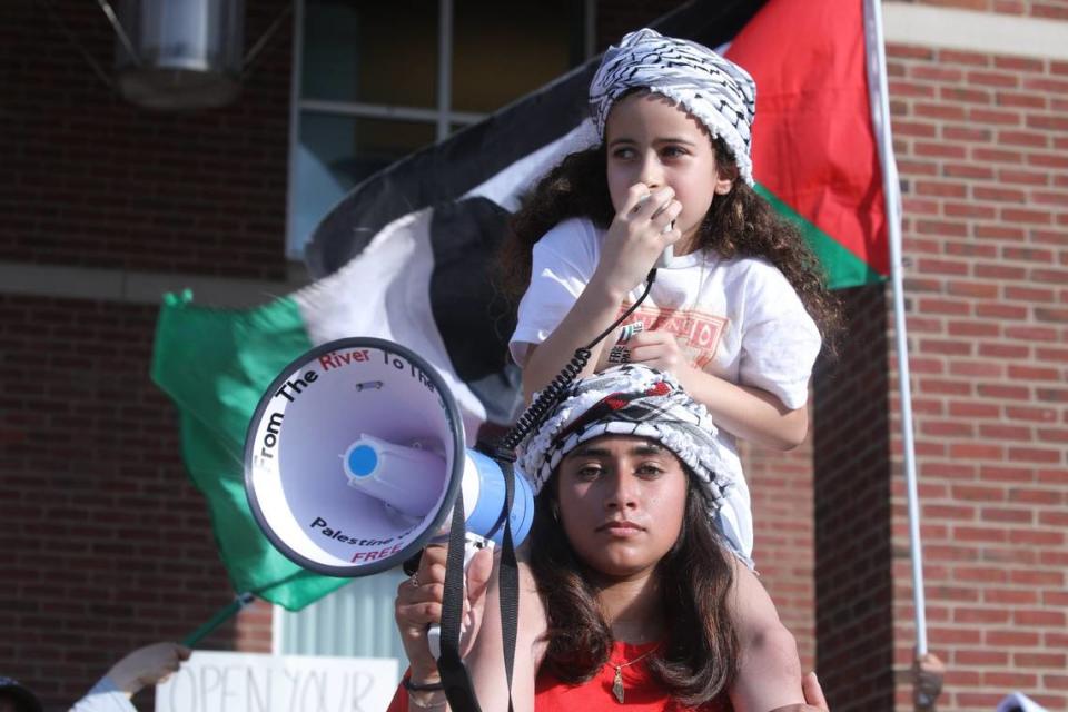 A young rally participant leading rally chants with megaphones during the peaceful Free Palestine rally at the William T Young Library lawn on UK’s campus on May 1, 2024, in Lexington, Ky.