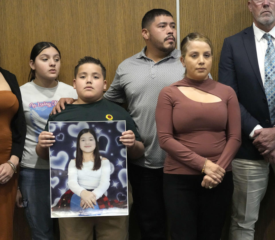 Arlene Alvarez's dad, Armando Alvarez, puts his arm around his son, Armando Alvarez Jr., 9, with wife Wendy during a press conference to discuss the indictment of Tony Earls in the death of the 9-year-old in 2022 at Crime Stoppers on Wednesday, April 24, 2024, in Houston. (Karen Warren/Houston Chronicle via AP)