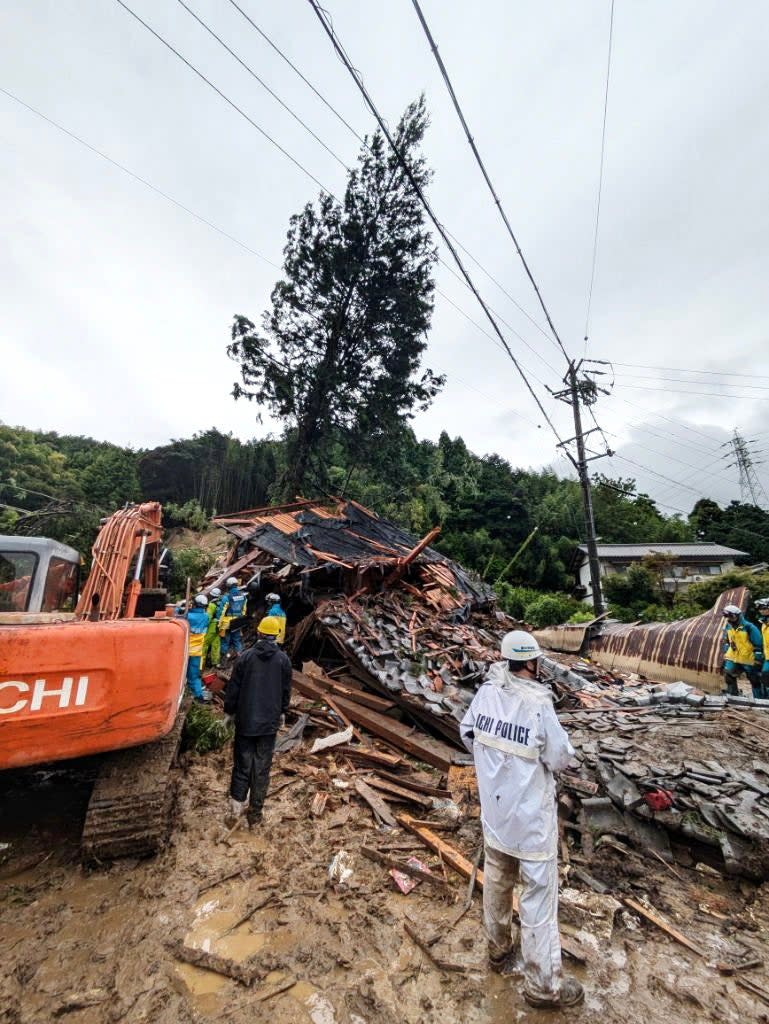 Rescue workers search for missing residents amid the ruins of a house in Gamagori, Aichi Prefecture (EPA)