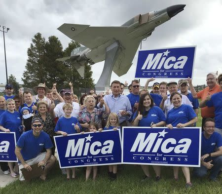 U.S. Representative John Mica (R-FL), (C) stands with campaign volunteers at Colonel Joe Kittinger Park in Orlando, Florida, U.S. October 15, 2016. REUTERS/Richard Cowan