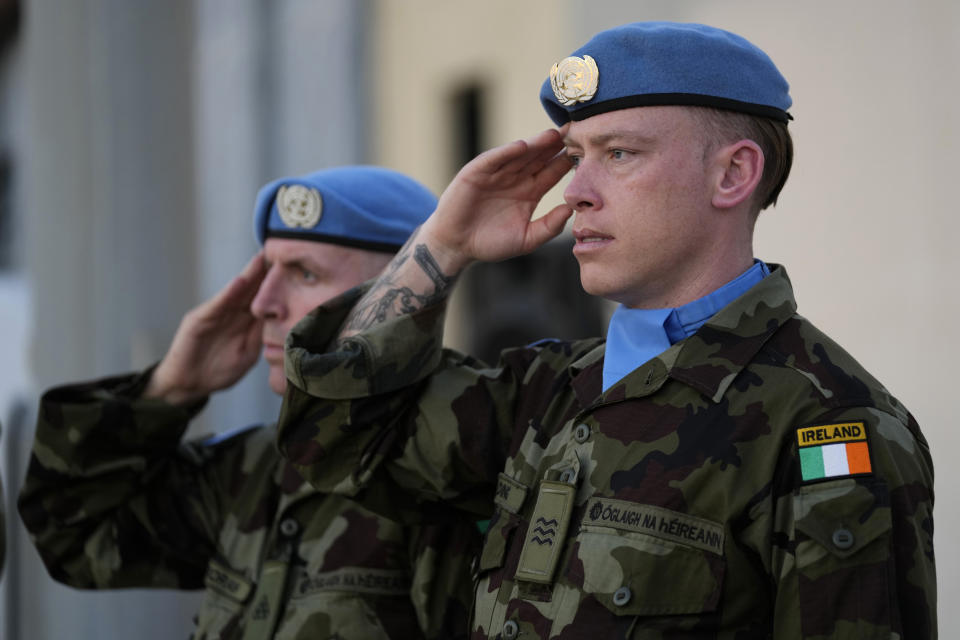 Irish U.N peacekeepers, salute as they attend the memorial procession of their comrade Pvt. Seán Rooney who was killed during a confrontation with residents near the southern town of Al-Aqbiya on Wednesday night, at the Lebanese army airbase, at Beirut airport, Sunday, Dec. 18, 2022. (AP Photo/Hussein Malla)