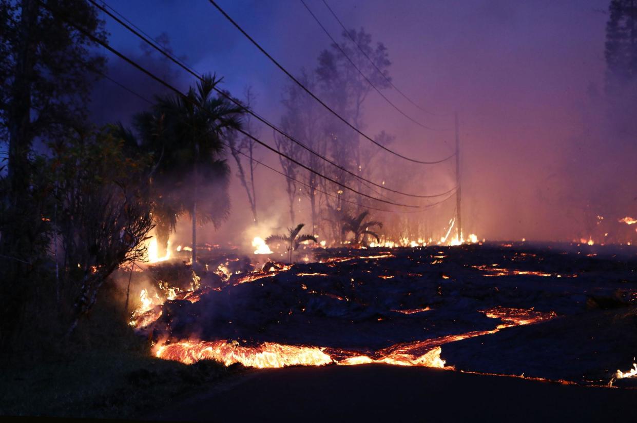 Lava from a Kilauea volcano fissure advances up a residential street in Leilani Estates, on Hawaii's Big Island, on May 27, 2018 in Pahoa, Hawaii: Mario Tama/Getty Images