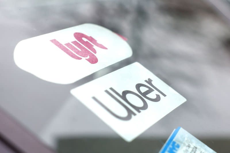 Lyft and Uber brand logos are in the dashboard of cars when the New York Taxi Workers Alliance (NYTWA) Uber and Lyft hold a work stoppage at a lot near LaGuardia airport on Sunday, February 26, 2023 in New York City. The strike kicked off with a rally and speak-out at the LaGuardia Uber/Lyft cell phone lot followed by picket lines throughout the airport. Photo by John Angelillo/UPI