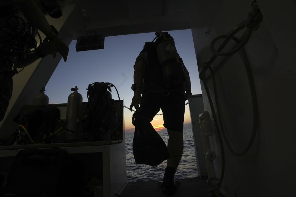 A diver steps off live aboard scuba dive boat visiting the Flower Garden Banks National Marine Sanctuary in the Gulf of Mexico, Friday, Sept. 15, 2023. (AP Photo/LM Otero)