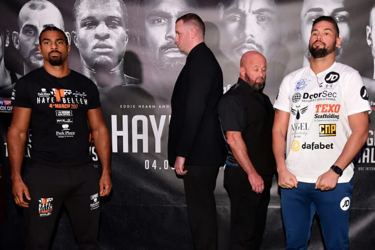 British boxers David Haye (L) and Tony Bellow (R) are seperated by security personel as they pose for photographers following a press conference
