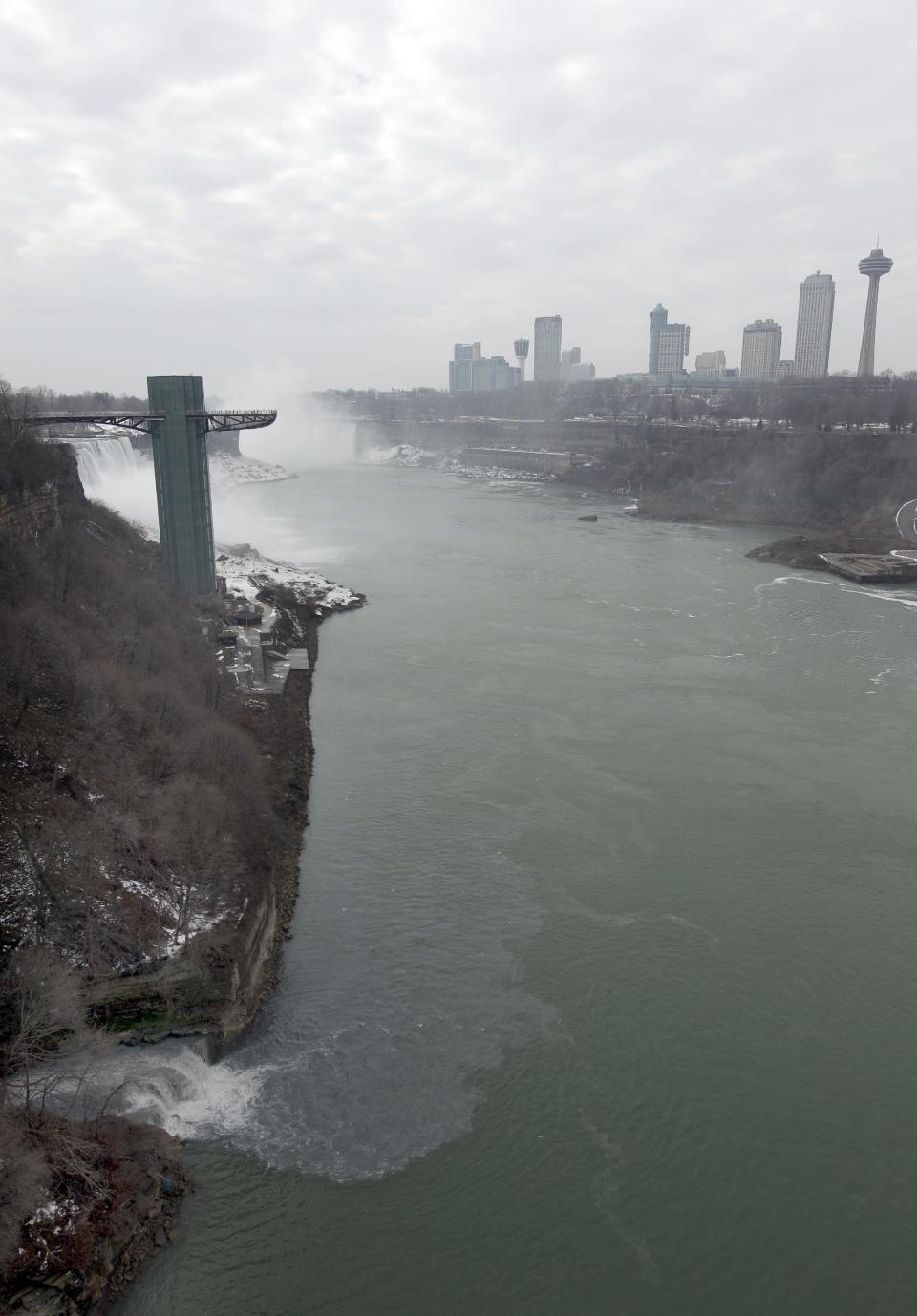 FILE - In this Feb. 17, 2012 file photo, effluent from the Niagara Falls Wastewater Treatment Plant is discharged into the Niagara River near the American Falls in Niagara Falls, N.Y. The Niagara Falls City Council voted Monday, March 5, 2012 to ban the treatment of wastewater from hydraulic fracturing. Leaders of the city that endured the Love Canal toxic waste crisis in the 1970s say they don’t want it to be a test case for so-called fracking waste. (AP Photo/David Duprey, File)