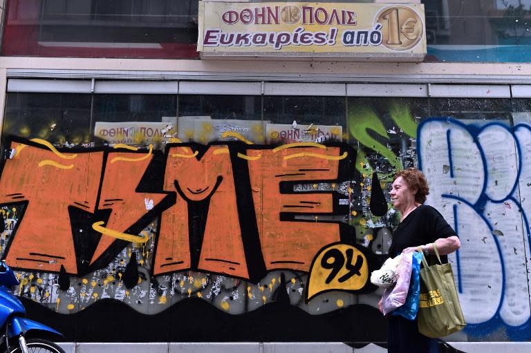 A shut down store in Athens is seen covered in graffitti, as Greece faces a series of debt repayments beginning next month