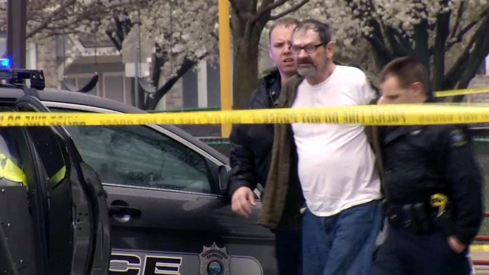 FILE - In this April 13, 2014 file image taken from video provided by KCTV-5, Frazier Glenn Cross is escorted by police in an elementary school parking lot in Overland Park, Kan. Authorities said Tuesday, April 15, that Cross has been charged with one count of capital murder for the deaths of a 14-year-old boy and his grandfather outside the Jewish Community Center of Greater Kansas City on Sunday. Cross also faces one count of first-degree, premeditated murder for the death of a woman who was gunned down while visiting her mother at a nearby retirement complex. (AP Photo/KCTV-5, File) MANDATORY CREDIT