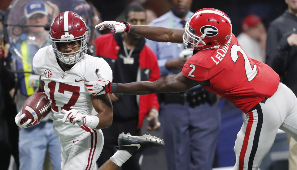 Georgia defensive back Richard LeCounte (2) misses Alabama wide receiver Jaylen Waddle (17) during the second half of the Southeastern Conference championship NCAA college football game, Saturday, Dec. 1, 2018, in Atlanta. (AP Photo/John Bazemore)