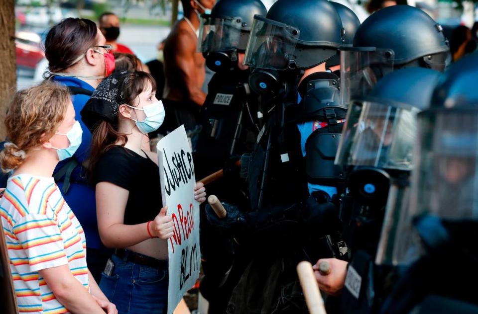 Demonstrators stand off with police during a protest in downtown Raleigh, N.C. Saturday, May 30, 2020.