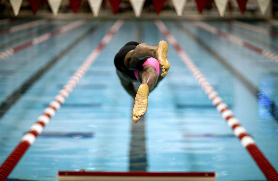 <p>Cullen Jones dives off a starting block in the final heat of the men’s 50-meter freestyle at the Bulldog Grand Slam swim meet at the University of Georgia, July 12, 2014, in Athens, Ga. (AP Photo/David Goldman) </p>