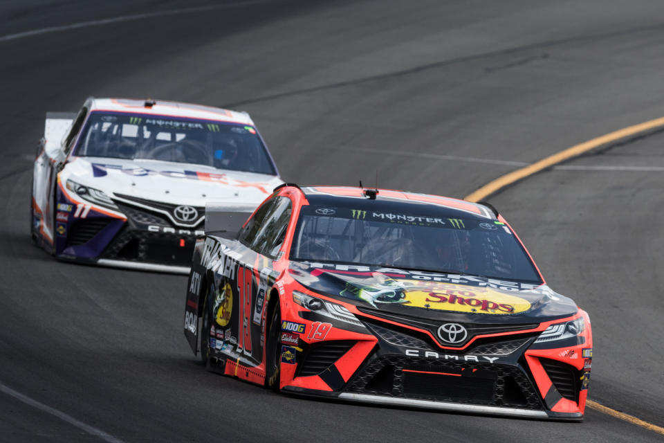 LONG POND, PA - JULY 28: Martin Truex Jr driver of the #19 Bass Pro Shops/Tracker Off Road Toyota races through turn 2 followed by teammate Denny Hamlin #11 during the Monster Energy NASCAR Cup Series, Gander Outdoors 400 on July 28, 2019, at Pocono Raceway in Long Pond, PA. (Photo by David Hahn/Icon Sportswire via Getty Images)