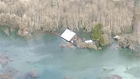 An aerial view of the area affected by a landslide near State Route 530 is seen in this handout photo provided by the Governor Jay Inslee's office taken near Oso, Washington March 23, 2014. REUTERS/Gov Jay Inslee's office/Handout via Reuters