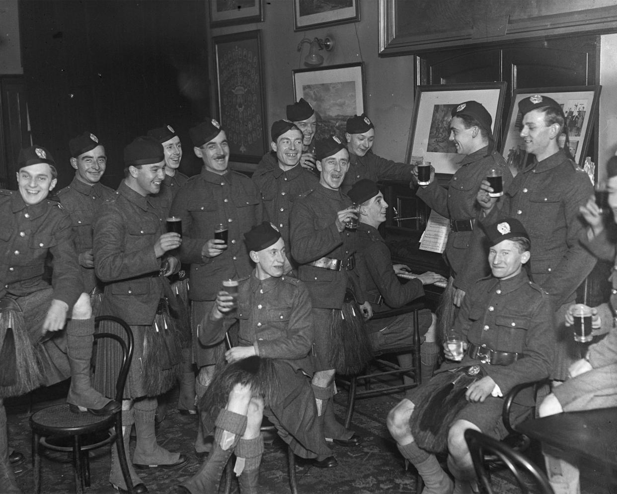 Kilted Scottish army recruits celebrating Halloween in London during World War I.