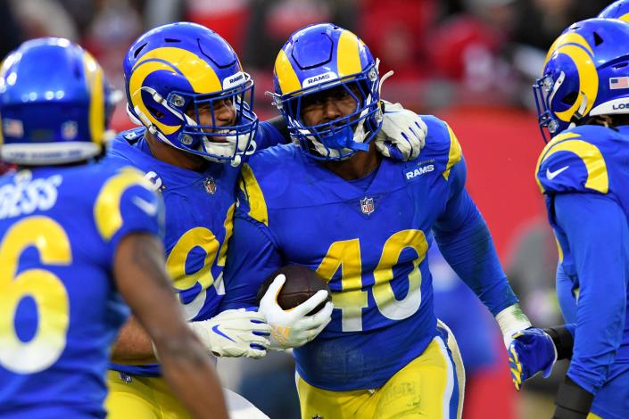 Los Angeles Rams outside linebacker Von Miller (40) celebrates with defensive end Aaron Donald (99) after Miller sacked Tampa Bay Buccaneers quarterback Tom Brady and caused a fumble during the second half of an NFL divisional round playoff football game Sunday, Jan. 23, 2022, in Tampa, Fla. (AP Photo/Jason Behnken)