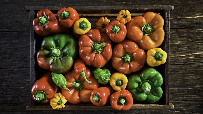 Assorted peppers inside wooden box