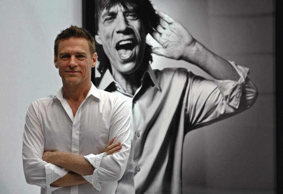 Bryan Adams and one of his portraits of Mick Jagger.