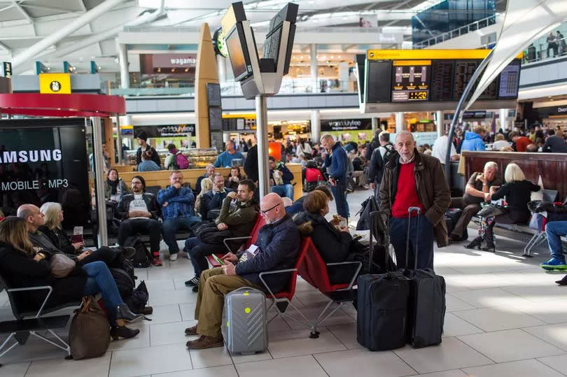 Airline passengers wait for their flight departures at Heathrow Airport in Terminal 5