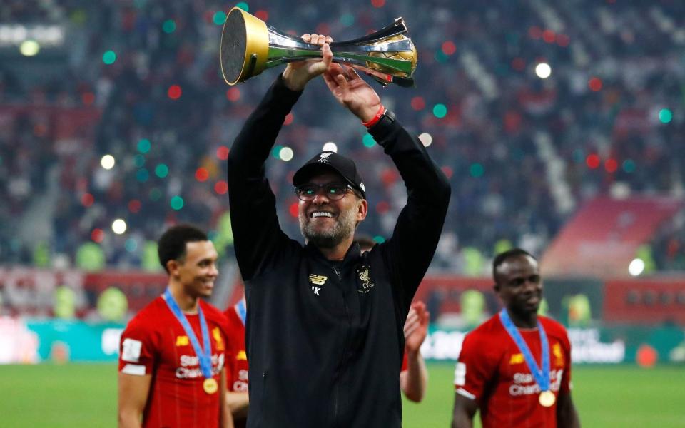 Jurgen Klopp holds up the Club World Cup