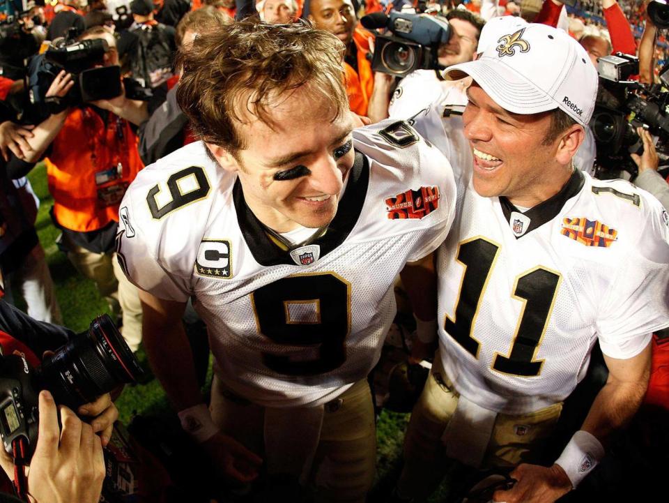 Mark Brunell celebrates with Drew Brees after the New Orleans Saints’ Super Bowl victory in 2010 (Getty)