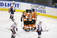 Philadelphia Flyers center Scott Laughton (21) celebrates his goal alongside teammates Travis Konecny (11), Kevin Hayes (13) Travis Sanheim (6) and Philippe Myers (5) during the third period of an NHL hockey playoff game Thursday, Aug. 6, 2020, in Toronto. (Cole Burston/The Canadian Press via AP)