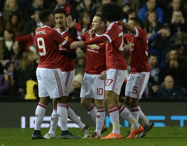 Manchester United players celebrate after scoring a goal during their FA Cup 4th round match against Derby County at Pride Park stadium in Derby, northern England on January 29, 2016